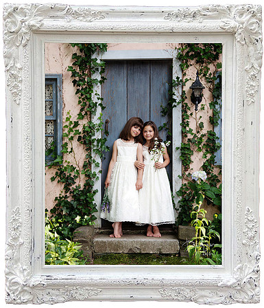 sisters in white dresses pose at the cottage door at the long island studio