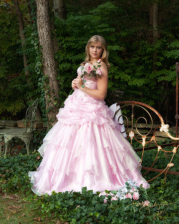 teen girl in long beautiful pink gown standing next to antique bed in a garden, Long Island, NY.